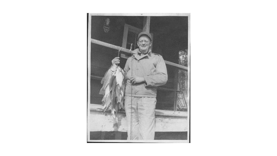 Burney with fish on Old Boathouse Porch